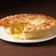 Apple pie on a plate with a slice missing
